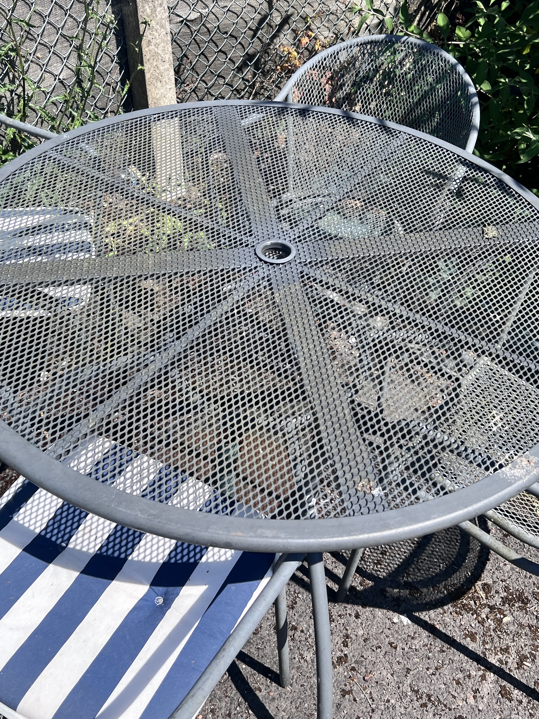 A Kettler circular metal garden table, diameter 110cm, height 72cm, and four chairs